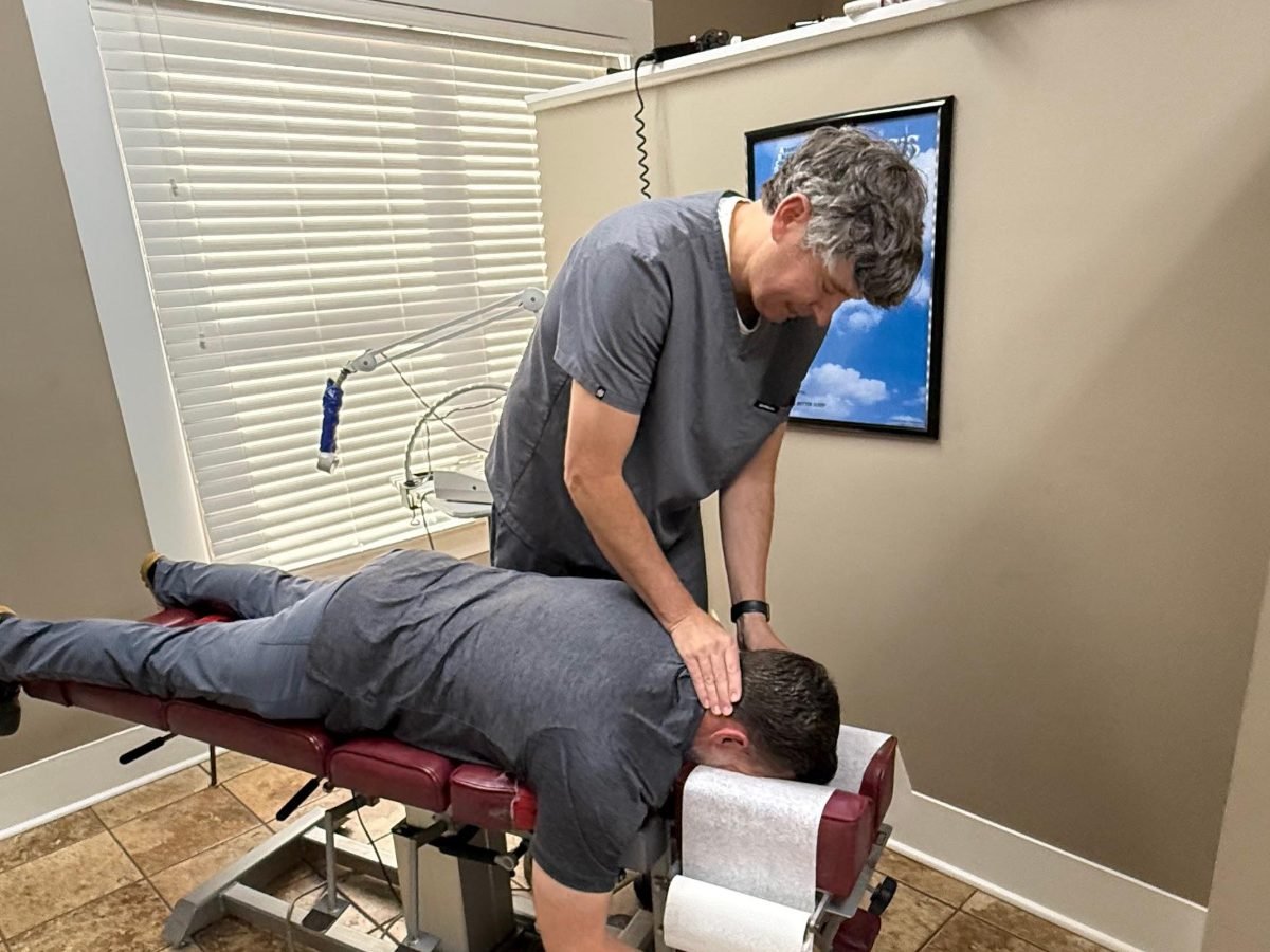 Dr. Channing King, DC performing a neck adjustment at King Family Chiropractic in Trussville, Alabama